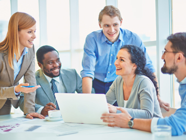 Group of colleagues working together with laptop